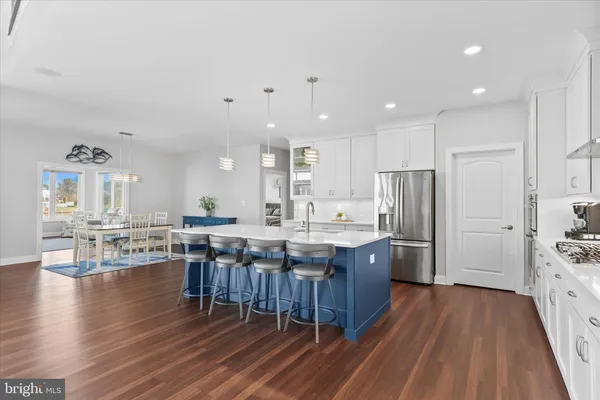 a spacious bedroom with a bed and a chandelier