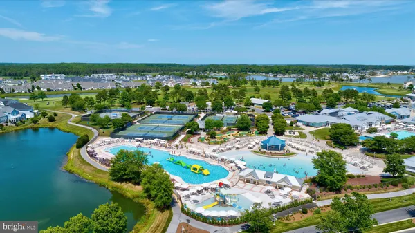 an aerial view of residential houses with outdoor space and swimming pool