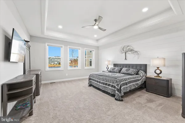 a bedroom with a large bed and a dresser