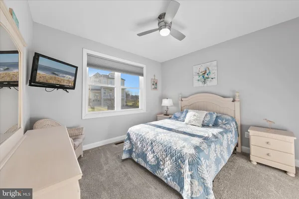 a bedroom with a bed table and a window