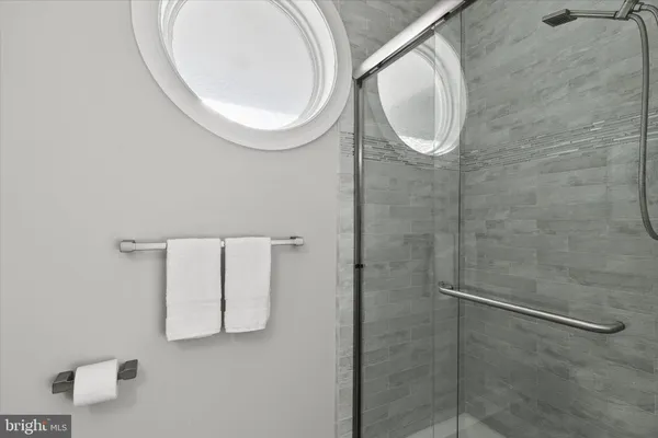 a front view of a house with a garden and trees