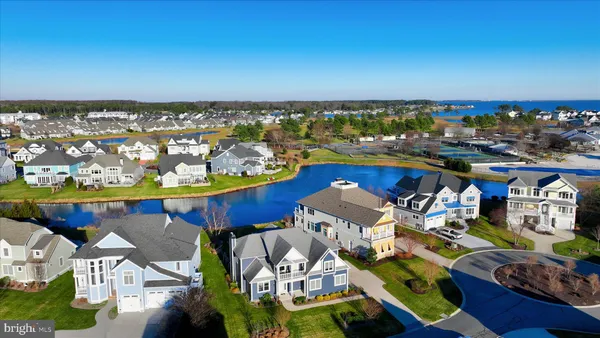 a large kitchen with lots of counter space a sink refrigerator and chairs