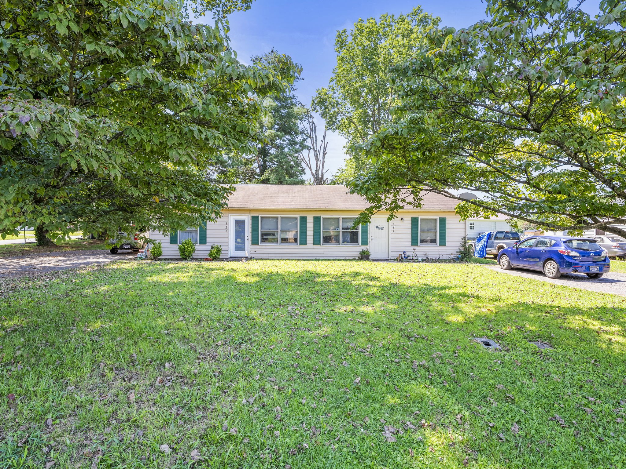 a front view of house with yard and green space