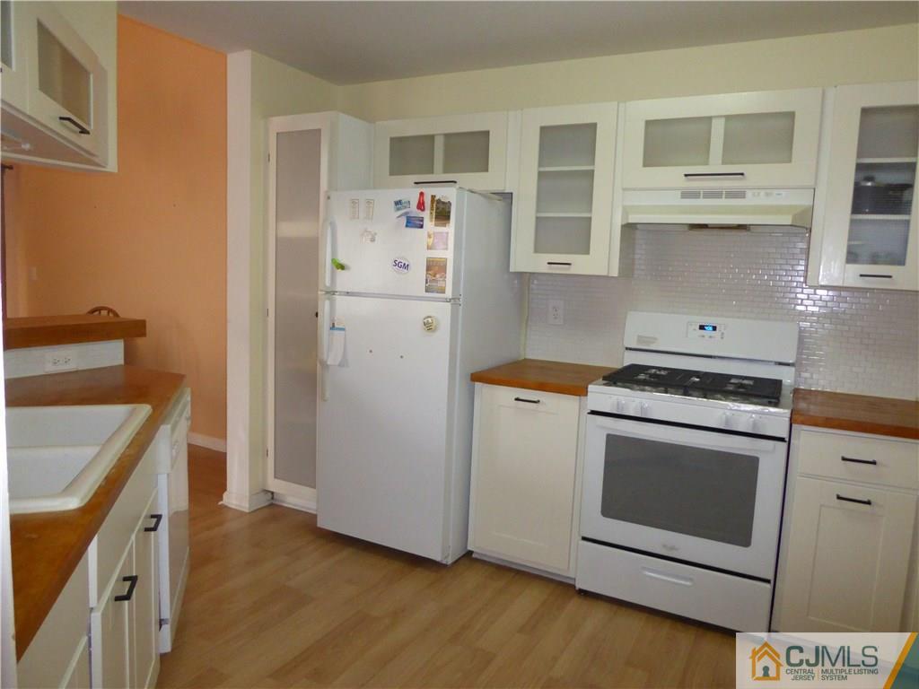 334 Edpas Road, Unit 334 New Brunswick, NJ 08901 - Photo 2 of 19 a kitchen with a stove top oven and cabinets