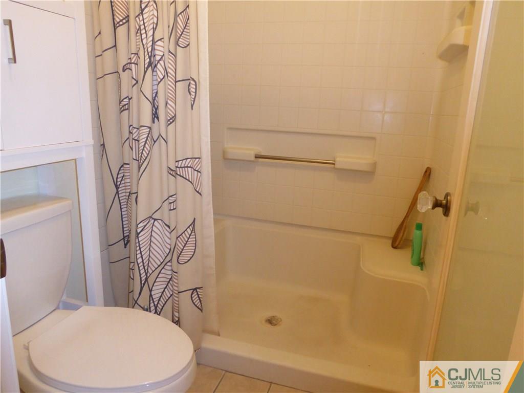 334 Edpas Road, Unit 334 New Brunswick, NJ 08901 - Photo 14 of 19 a white toilet sitting next to a bathroom