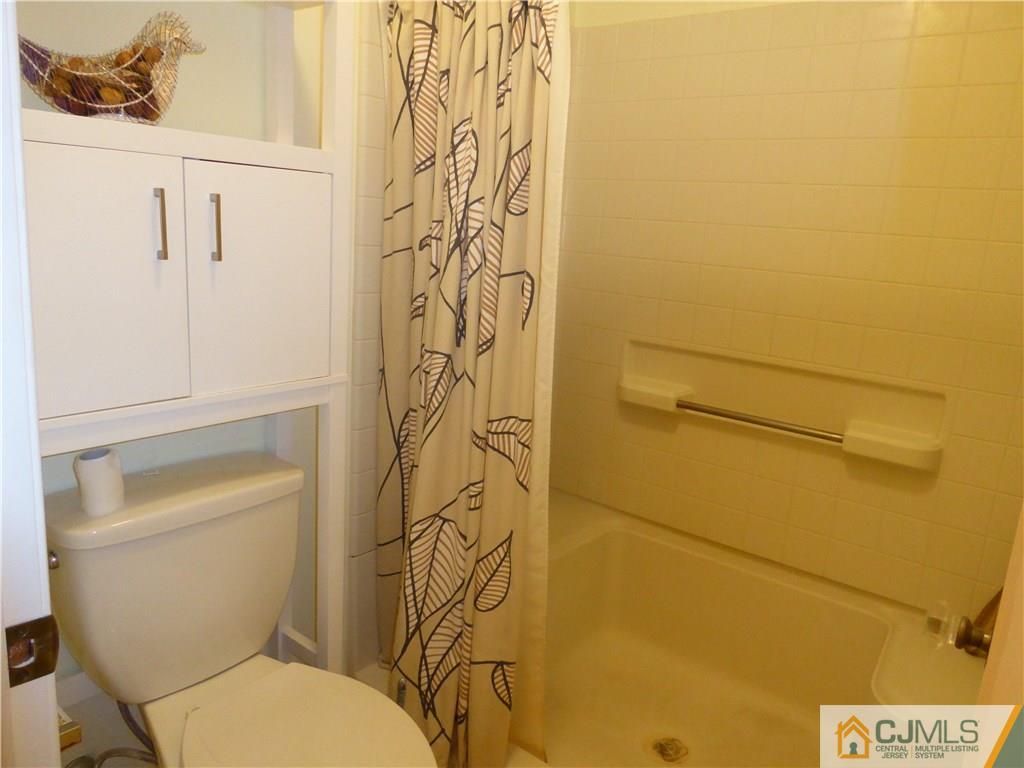 334 Edpas Road, Unit 334 New Brunswick, NJ 08901 - Photo 15 of 19 a white toilet sitting next to a shower curtain