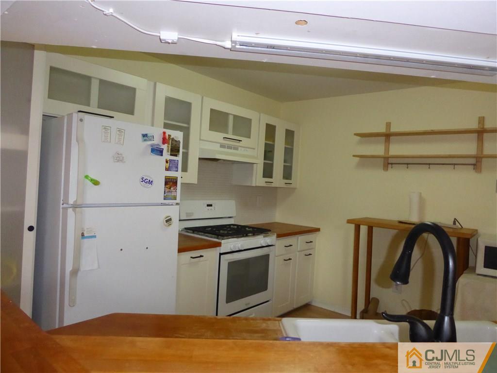 334 Edpas Road, Unit 334 New Brunswick, NJ 08901 - Photo 4 of 19 a kitchen with stainless steel appliances granite countertop a refrigerator and a stove top oven