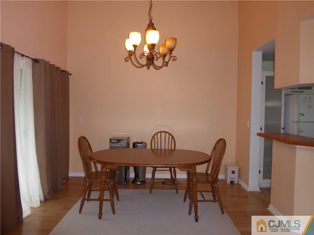 334 Edpas Road, Unit 334 New Brunswick, NJ 08901 - Photo 5 of 19 a view of a dining room with furniture and chandelier