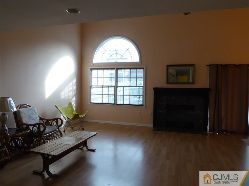 334 Edpas Road, Unit 334 New Brunswick, NJ 08901 - Photo 6 of 19 a living room with furniture and a large window