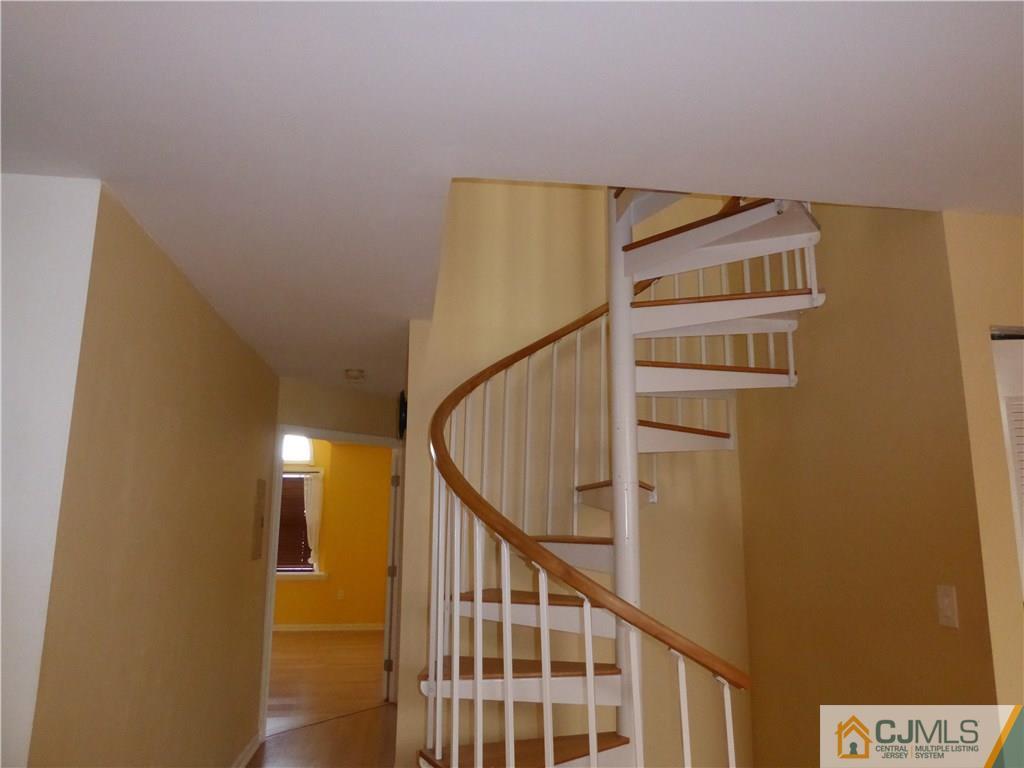 334 Edpas Road, Unit 334 New Brunswick, NJ 08901 - Photo 8 of 19 a view of staircase with wooden floor and white walls