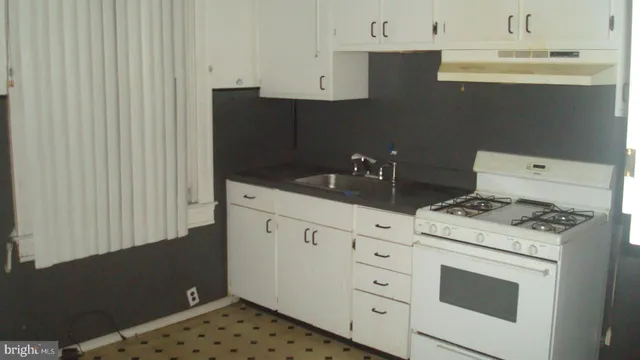 a kitchen with a stove and a sink