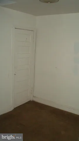 an empty room with a wooden door