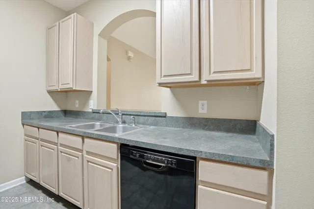 a kitchen with granite countertop cabinets and steel stainless steel appliances