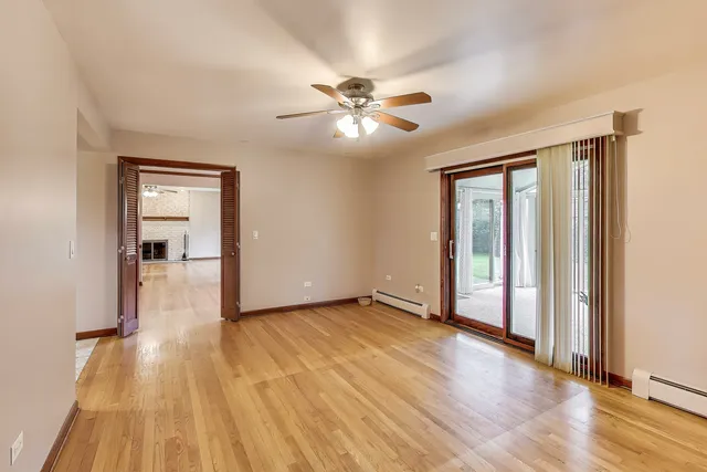 a view of empty room with wooden floor