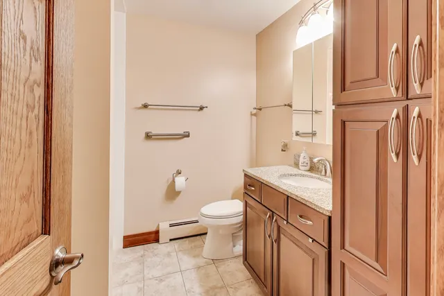 a bathroom with a granite countertop sink toilet and shower