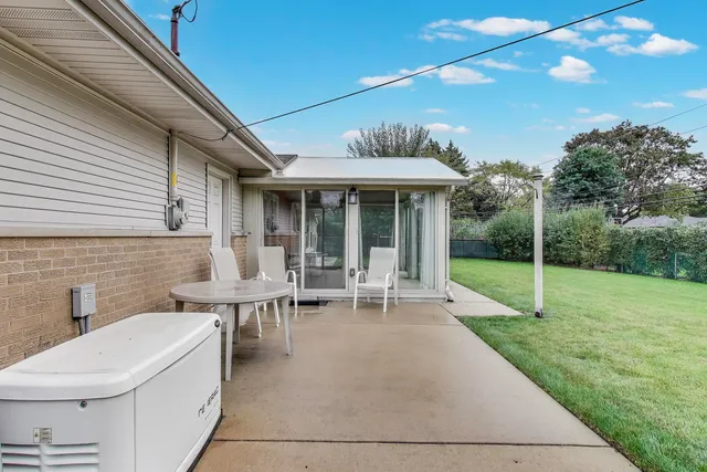 a view of a patio with table and chairs and potted plants