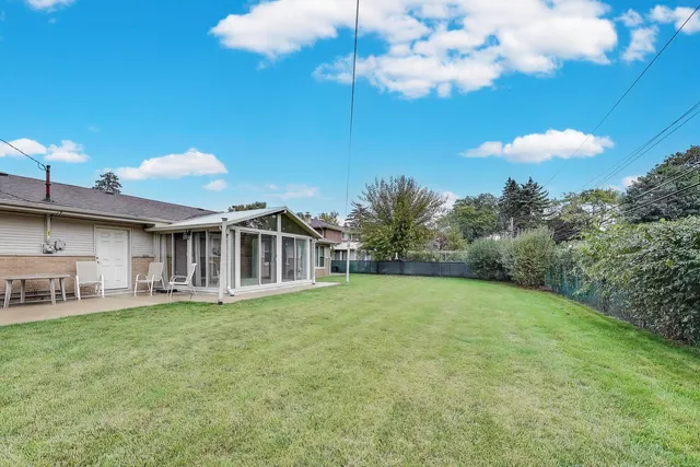 a big house with a big yard and large trees