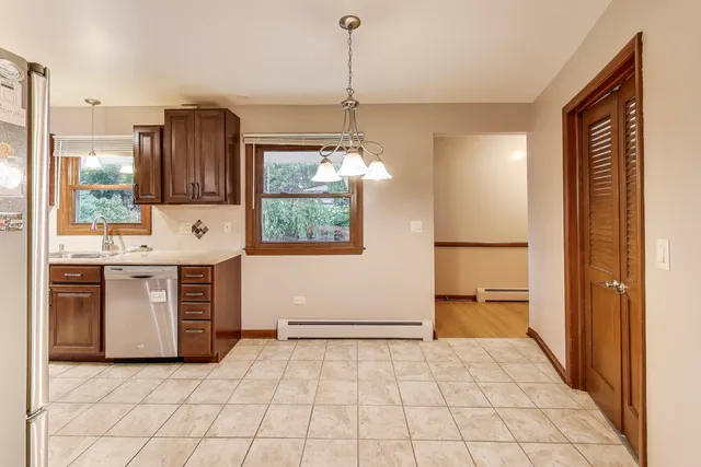a kitchen with a refrigerator a stove a sink and a window
