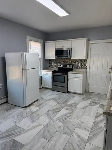 a kitchen with stainless steel appliances cabinets and a sink