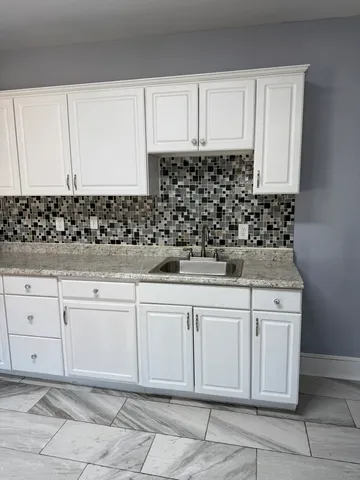 a kitchen with white cabinets