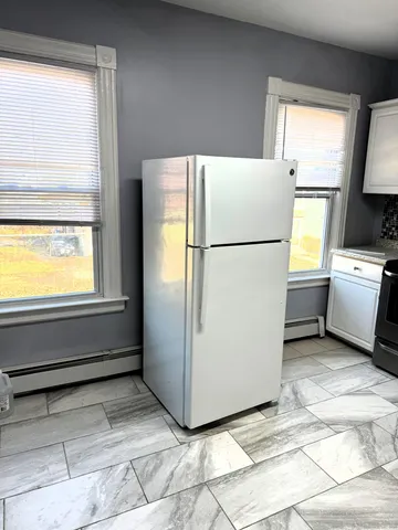 a white refrigerator freezer sitting in a kitchen