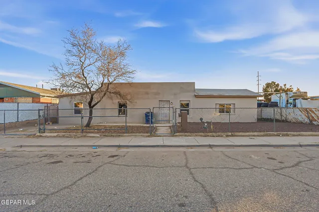 a view of a dirt road and a building in the background