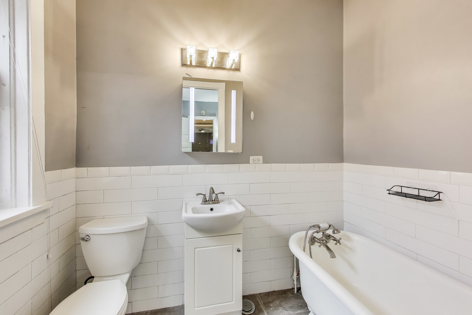 1615 East Hyde Park Boulevard, Unit 2 Chicago, IL 60615 - Photo 14 of 19 a bathroom with a sink a toilet and mirror