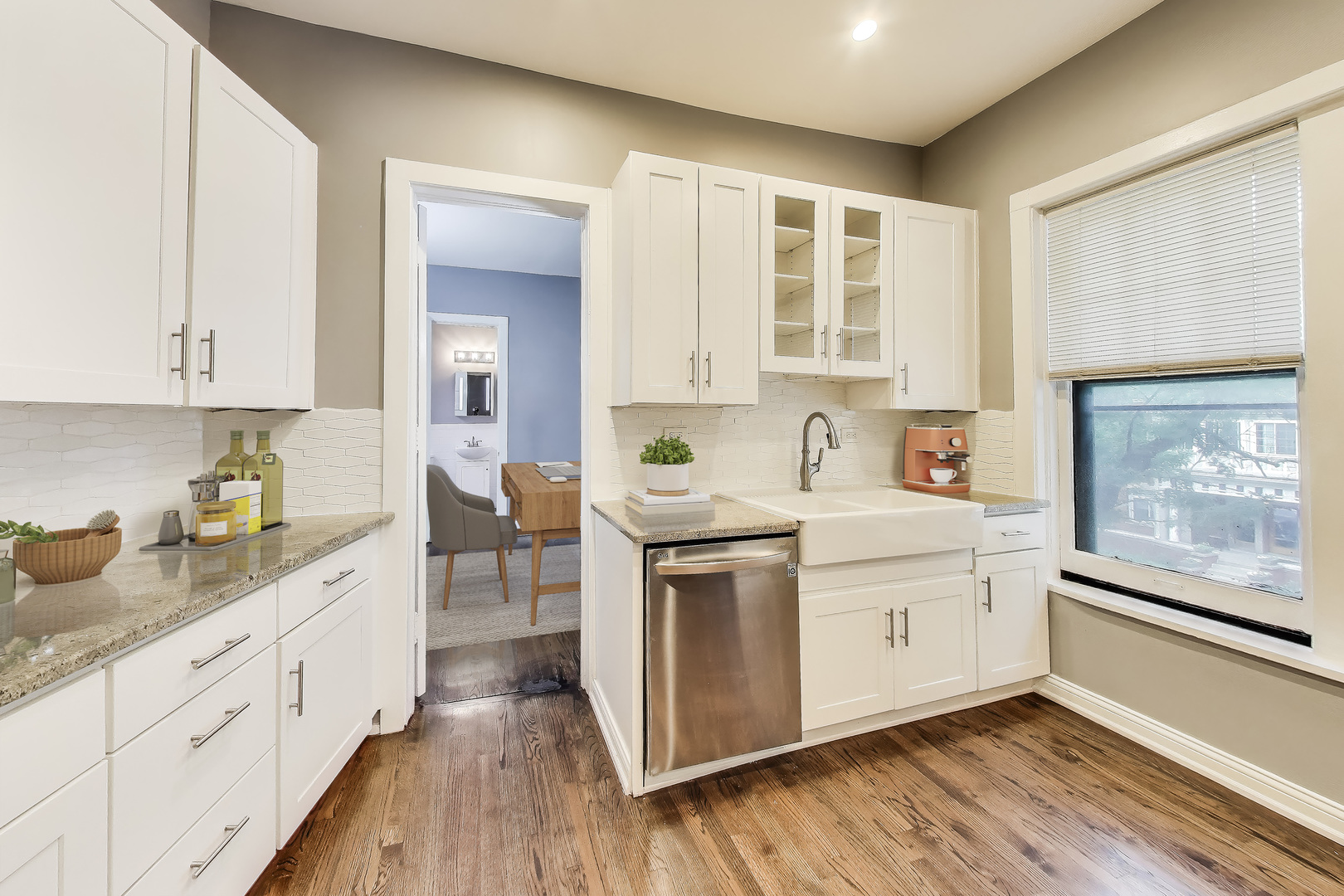 1615 East Hyde Park Boulevard, Unit 2 Chicago, IL 60615 - Photo 2 of 19 a kitchen with white cabinets and wooden floor