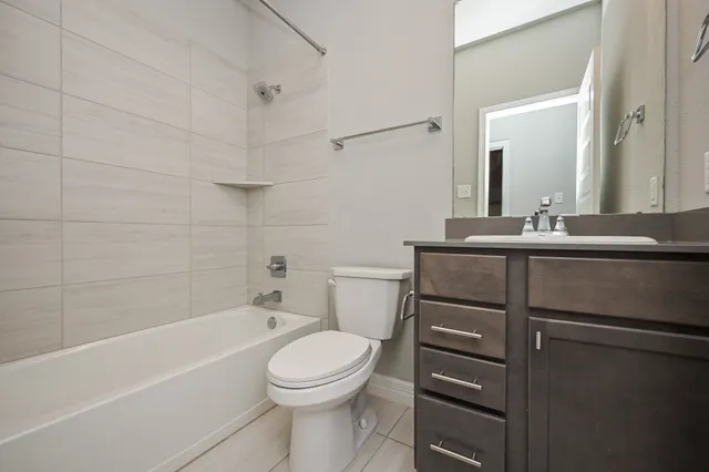 a bathroom with a sink a toilet and bathtub