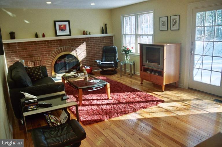 7644 Chancellor Way Springfield, VA 22153 - Photo 9 of 29 a living room with furniture a flat screen tv and a fireplace