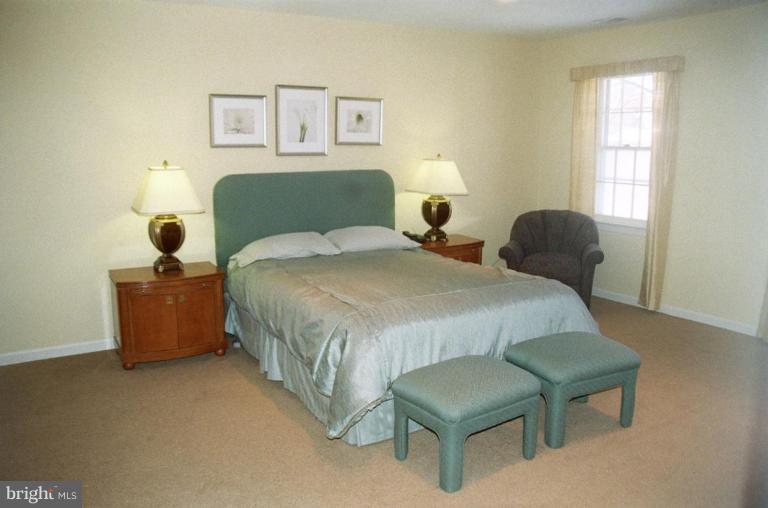 7644 Chancellor Way Springfield, VA 22153 - Photo 15 of 29 a bedroom with a bed and a chair
