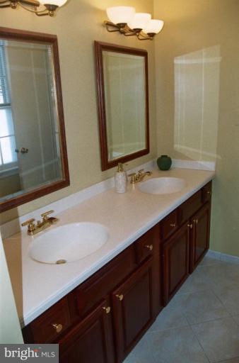 7644 Chancellor Way Springfield, VA 22153 - Photo 17 of 29 a bathroom with a sink vanity and a mirror