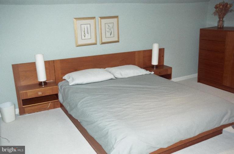 7644 Chancellor Way Springfield, VA 22153 - Photo 20 of 29 a bedroom with a bed and a cabinets