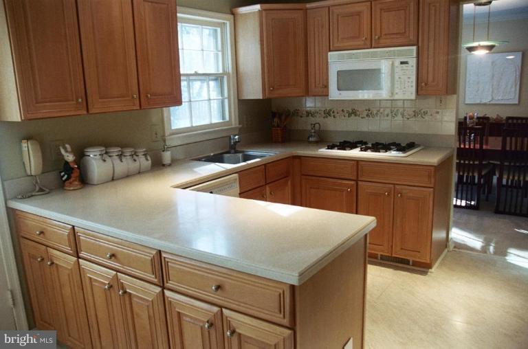 7644 Chancellor Way Springfield, VA 22153 - Photo 5 of 29 a kitchen with stainless steel appliances granite countertop a sink stove and refrigerator