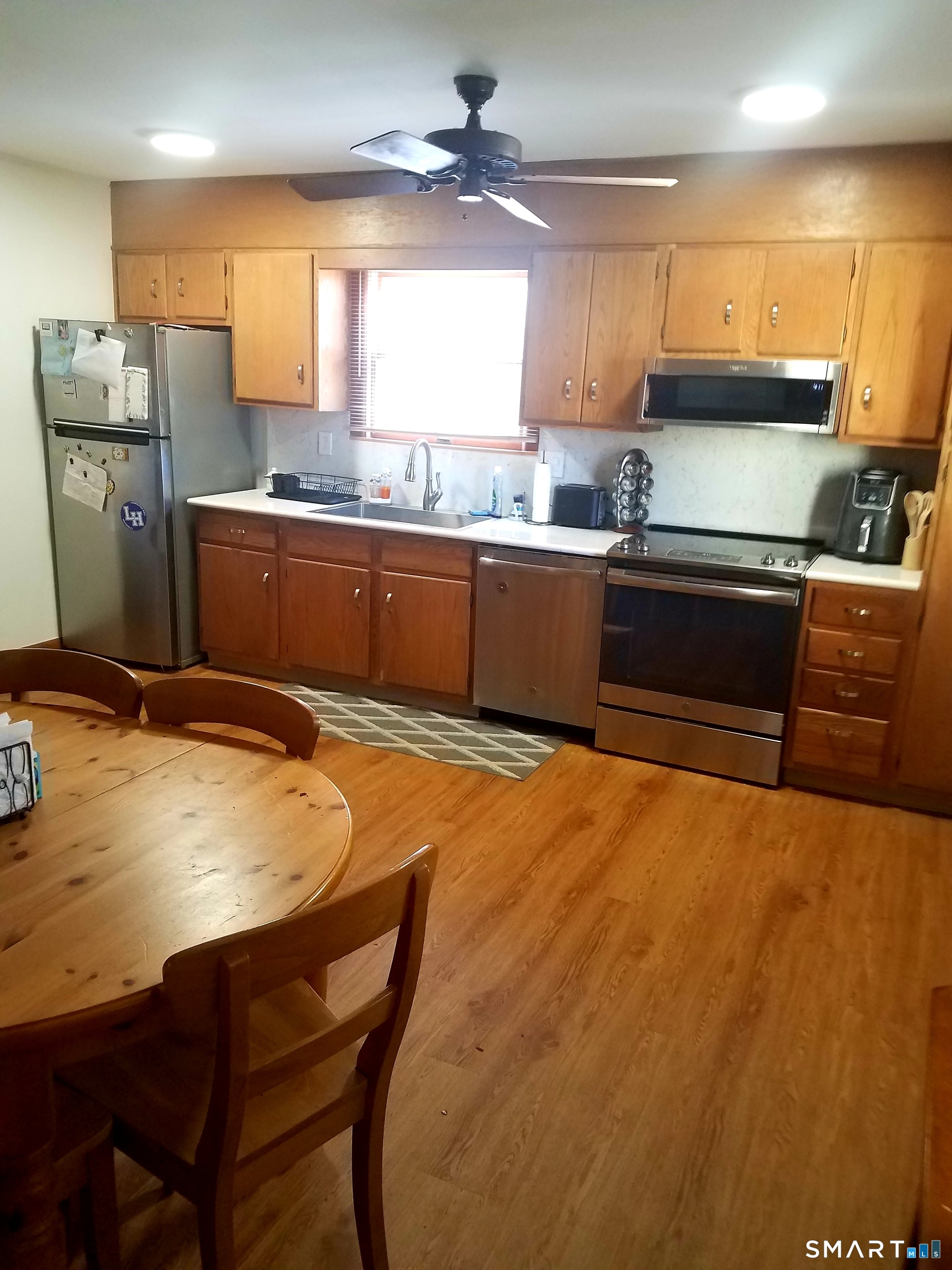 72 Maple Tree Avenue, Unit 2 Stamford, CT 06906 - Photo 6 of 29 Open layout to deck. Newer stainless steel appliances. Ceiling fan.