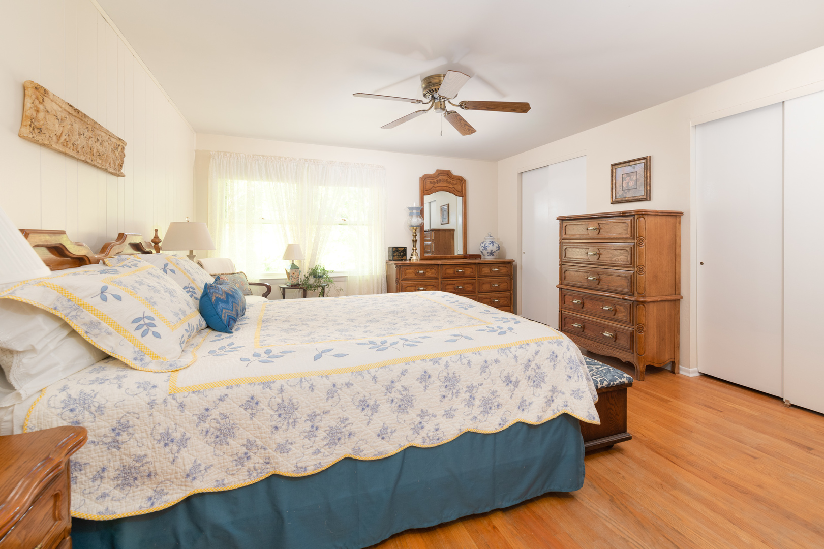 546 Northgate Road Lindenhurst, IL 60046 - Photo 11 of 26 a bedroom with a bed a dresser and a chandelier