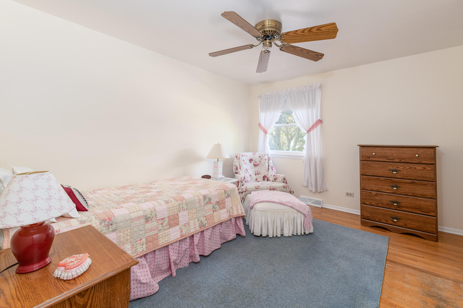 546 Northgate Road Lindenhurst, IL 60046 - Photo 17 of 26 a bedroom with bed and a chandelier
