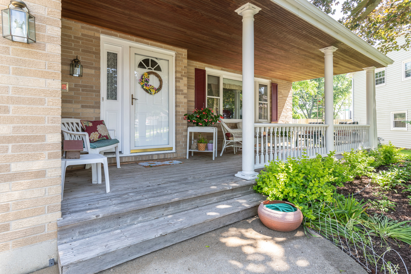 546 Northgate Road Lindenhurst, IL 60046 - Photo 2 of 26 a view of a deck with chair and potted plants