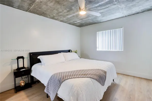 a bedroom with bed and a chandelier