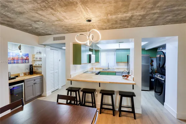 a kitchen with stainless steel appliances granite countertop a refrigerator and a sink