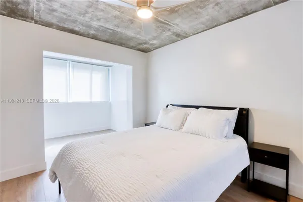 a bedroom with a bed and a window