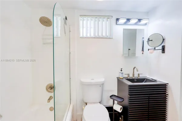 a bathroom with a sink a toilet and mirror
