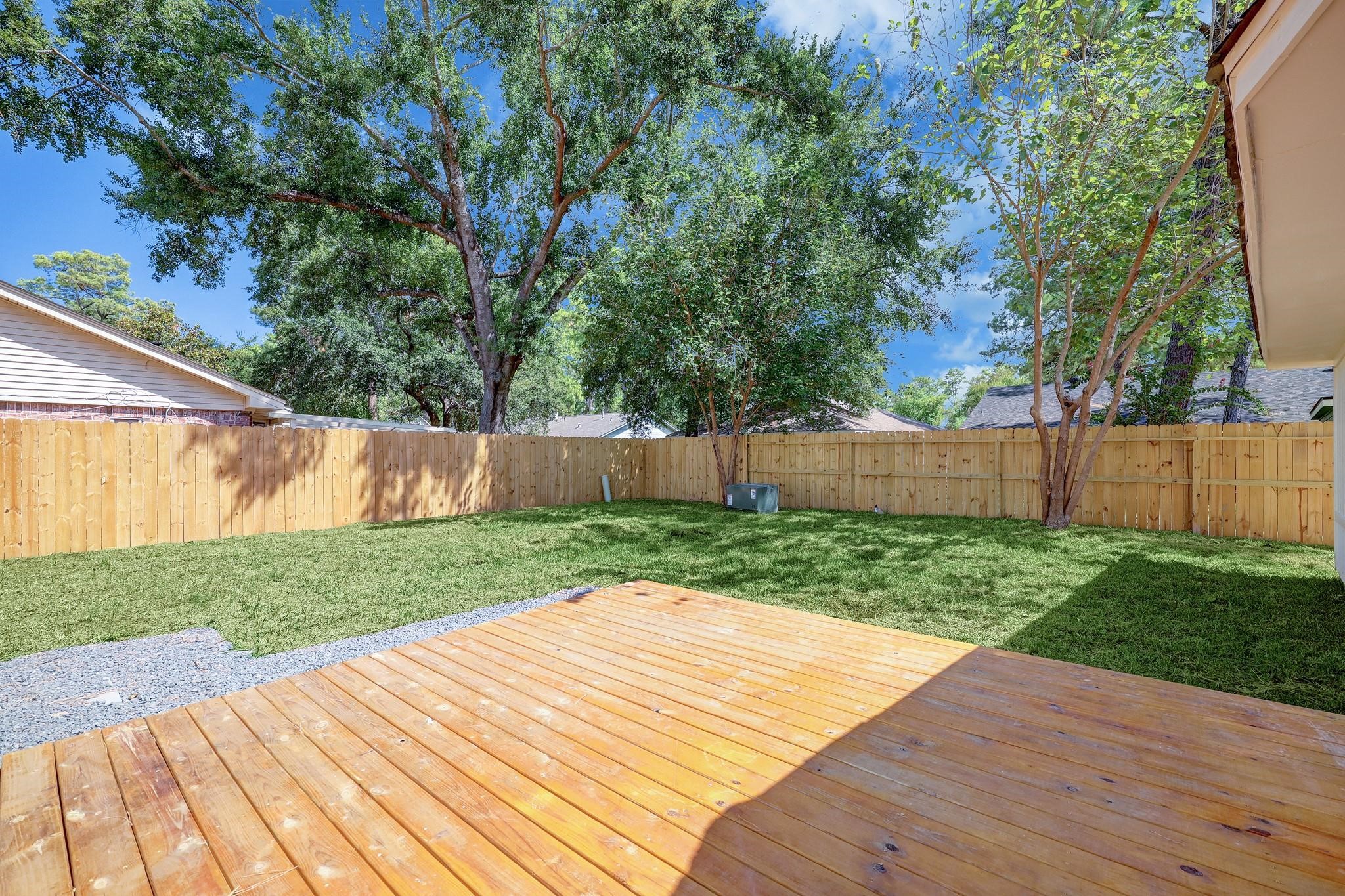 9723 Galston Lane Spring, TX 77379 - Photo 22 of 24 Stretching from the back of the home, the wooden deck provides a setting for al fresco dining or morning coffee, overlooking the private backyard oasis.