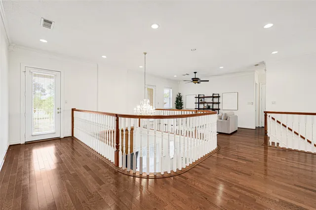 a open kitchen with white cabinets and wooden floor