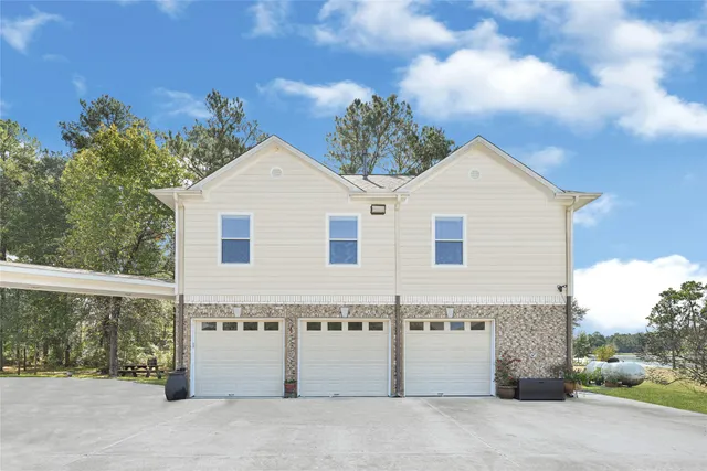 a view of a white house with a yard and balcony