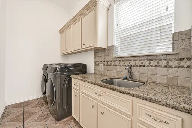 a kitchen with granite countertop a sink and cabinets