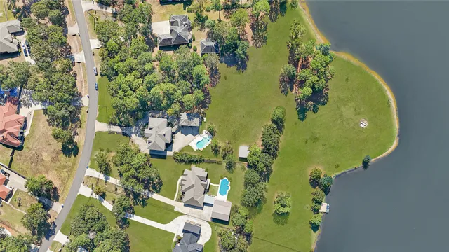 an aerial view of a residential houses with outdoor space