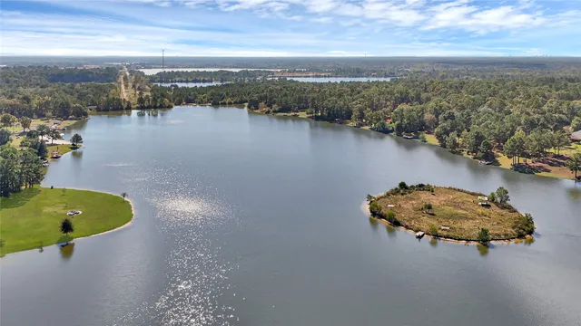 an aerial view of a house with a lake view