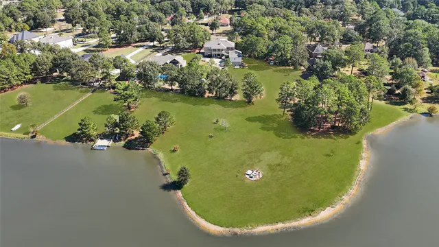 an aerial view of a residential houses with outdoor space and swimming pool