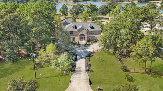 an aerial view of a house with a yard swimming pool and outdoor seating